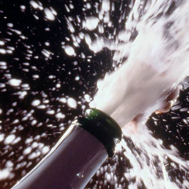 Sekt spritzt aus einer Flasche